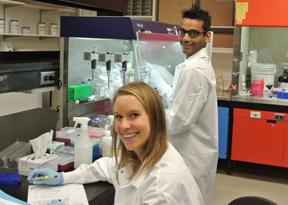 Two smiling students engaged in cancer projects at Berman Lab.