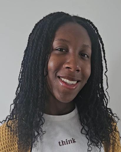 A photo of Michelle. She is a young Nigerian woman and is smiling.