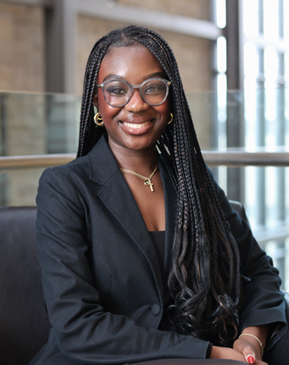 A photo of Chloe. She is a young Black woman and is smiling.