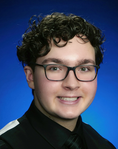 A photo of Evan. He is a young white man wearing glasses and is smiling.